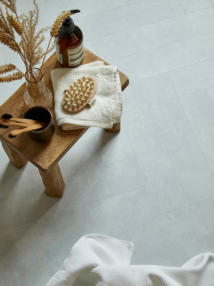 Floor features Rialto Concrete in Large Parquet with neutral home accessories.