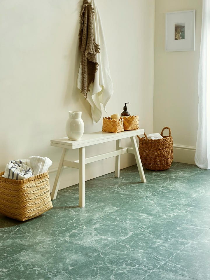 Hallway features Verde Classic Marble in a Uniform Tile with neutral toned walls and soft furnishing.