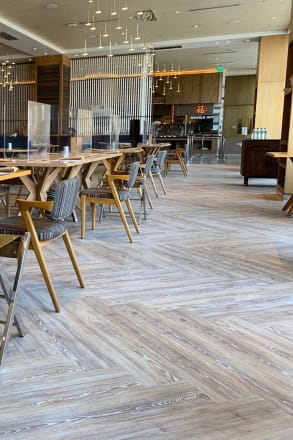 Striking worn ash herrinbone flooring in a hotel restaurant