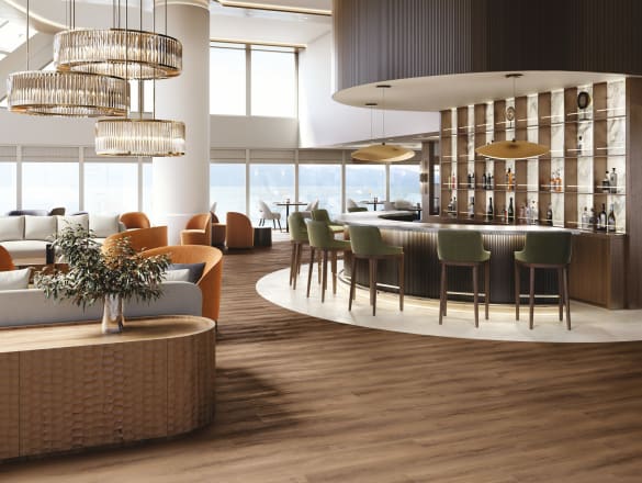 Striking Oak LVT flooing in stripwood with White marble surrounding bar area in a ship's lounge