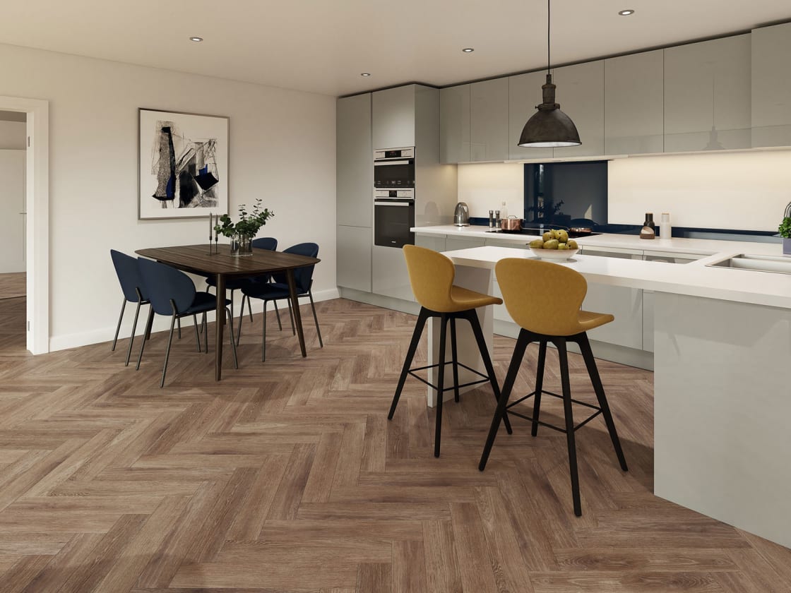 The open-plan kitchen features Smouldered Oak in Parquet , from the Amtico Click Smart collection.