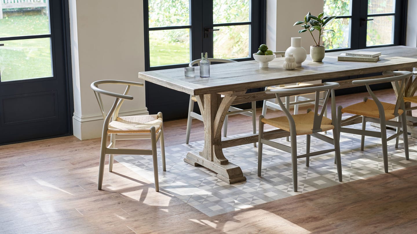 Dining area features Geo Melrose being used as a rug effect design, paired with Toulouse Oak.