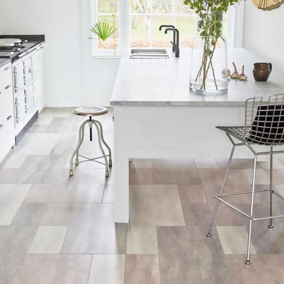 Kitchen with island and warm tones stone flooring