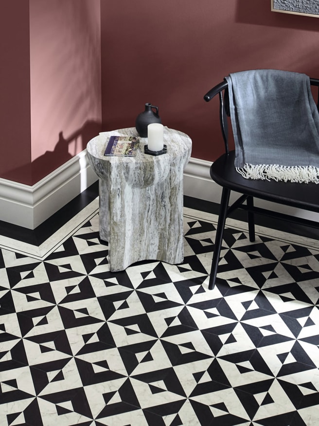 Amtico Echo Keys creates bold visual appeal in this Georgian-style home, with black and white marble-effect LVT complemented by dark red tones on a feature wall.