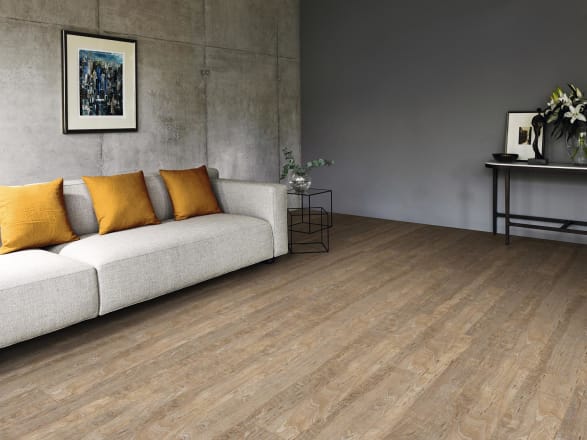 Weathered wood effect flooring with grey and brown tones in a living room