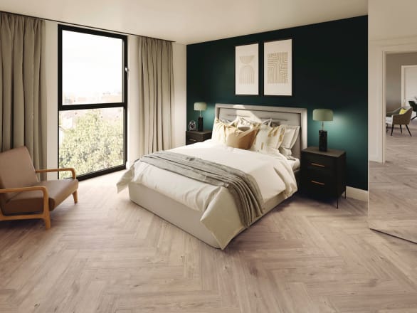 Fresh and bright oak-effect flooring tiles in parquet laying pattern in a bedroom