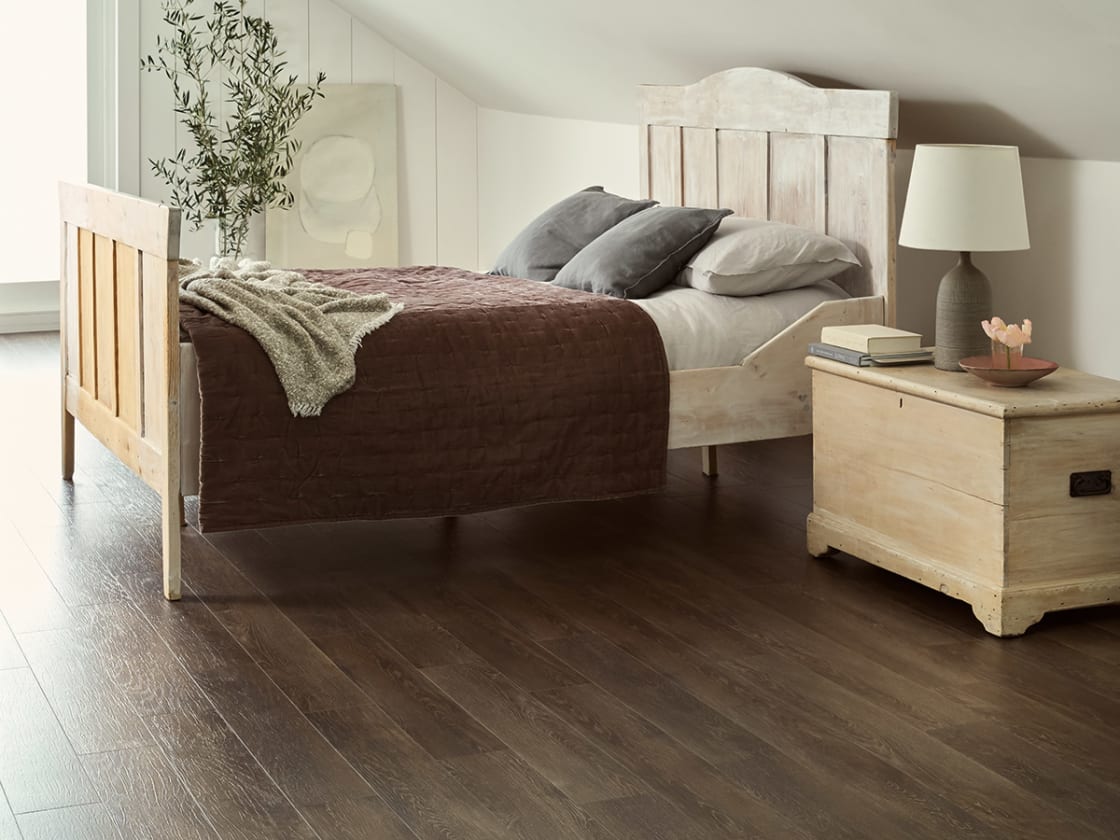Bedroom floor features Bister Oak in Stripwood
