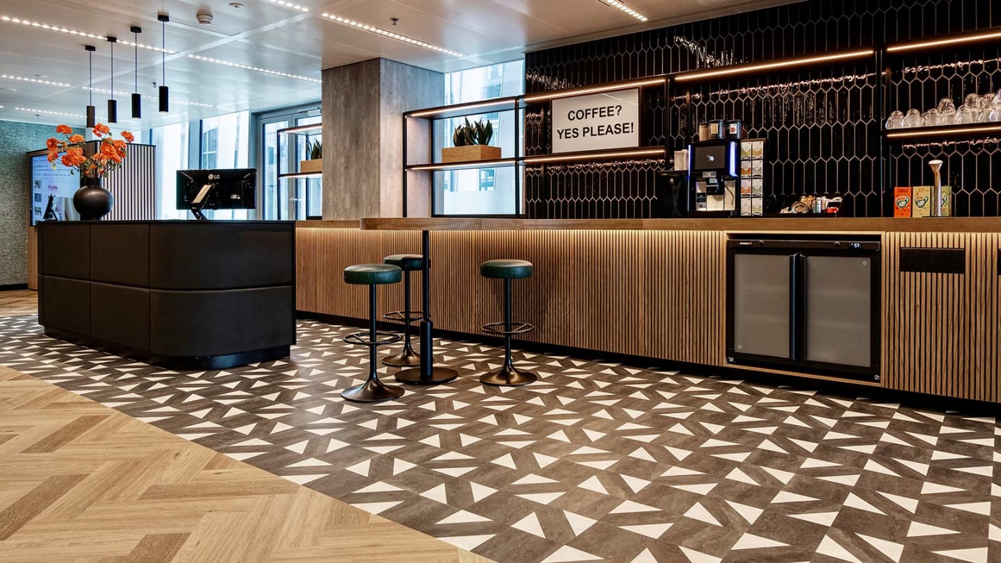 The bar features wood paneling and black tiles paired with a contrasting white and black floor pattern.