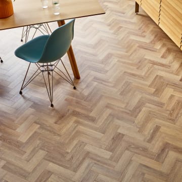 Brown wood-effect small floor planks in a parquet laying pattern