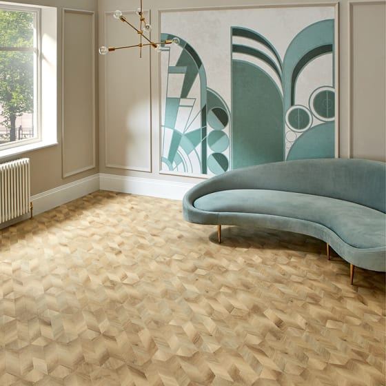 Sandy-coloured wood-effect floor planks in a venetian parquet laying pattern