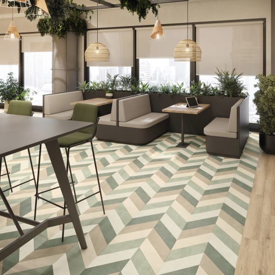 Green and neutral-toned floor planks in a parquet pattern in a commercial space