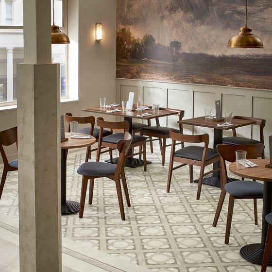 Stone-effect floor tiles in light grey tones and the corinthian laying pattern in a restaurant