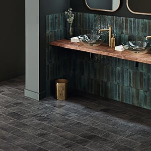 Dark grey rectangle tiles in simple laying patten in a bathroom