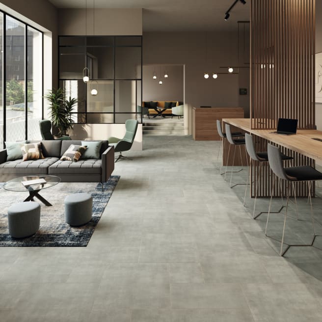 Light grey concrete-effect floor tiles in a commercial space