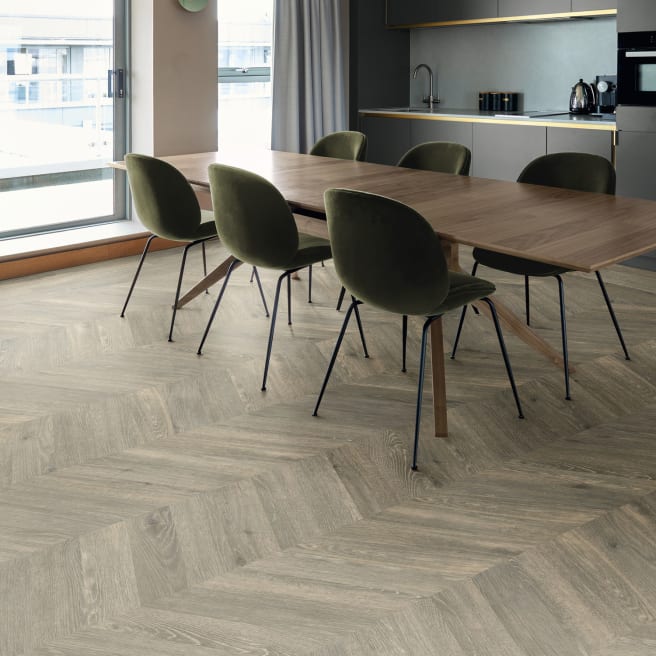 Oak wood-effect floor planks in a chevron flooring pattern
