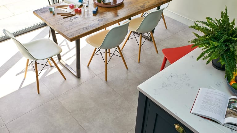 Large concrete effect tiles in a kitchen-diner